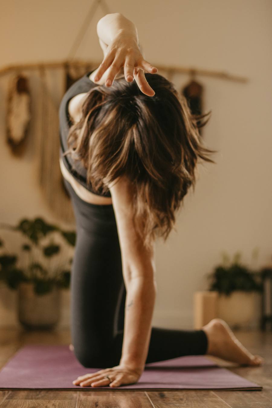 A kneeling twist on a mat in the studio