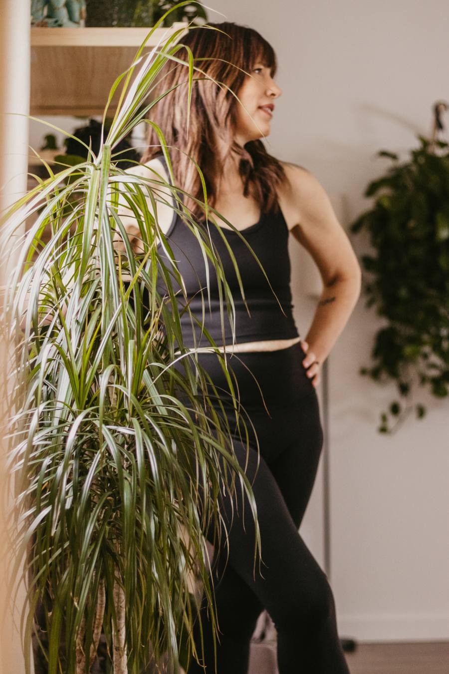 Standing among the plants in the studio